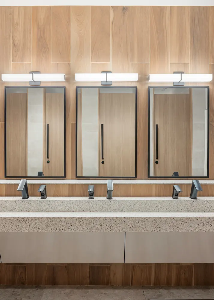 City Hall gender-neutral washroom — Mirrors and lighting over the trough sink