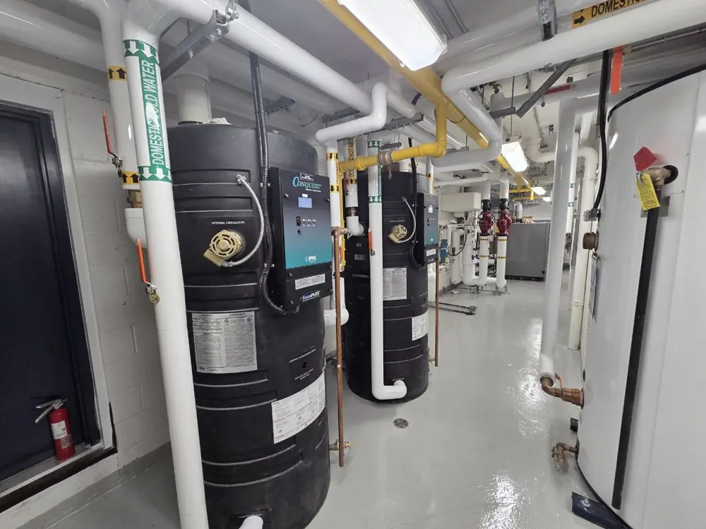 Arrow mechanical site photo — Domestic hot water tanks and piping